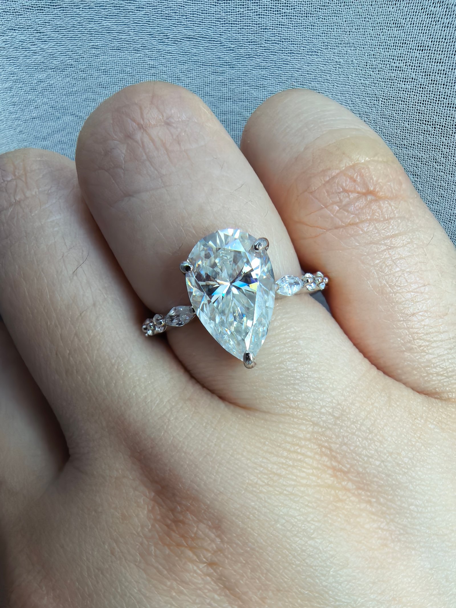 4 carat pear cut engagement ring with side stones